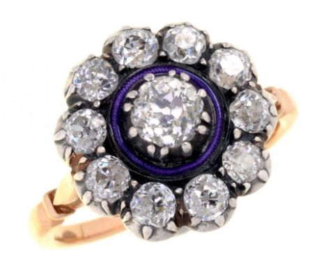 A DIAMOND CLUSTER RING, LATE 19TH/EARLY 20TH C  with old cut diamonds, the largest separated by  mauve guilloche enamel circl