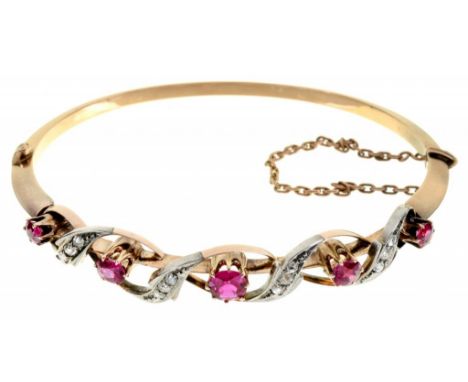 A RUBY AND DIAMOND BANGLE, C1900  the knife wire with five rubies entwined with diamonds, in gold, 64mm, 14g++Good condition