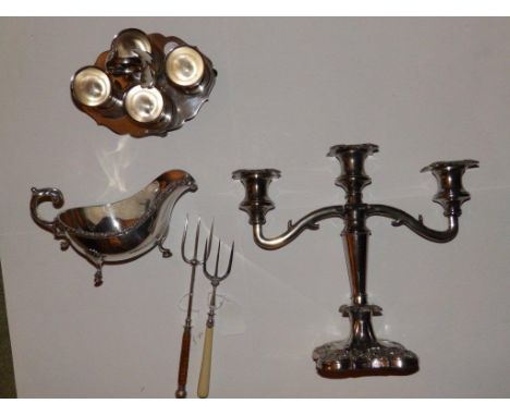 An EP candelabrum, a sauce boat, an egg cup stand and two bread forks