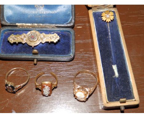 A 9ct brooch, three rings and a 15ct stick pin (5)