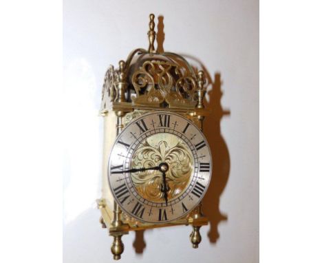 A  reproduction brass lantern style clock fitted with a French strking carriage clock movement, 10”