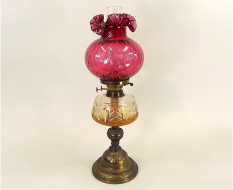 OIL LAMP.
A Victorian brass oil lamp with cut glass fount & cranberry glass shade.
Full height 62cm.
NOTE: In-house shipping 