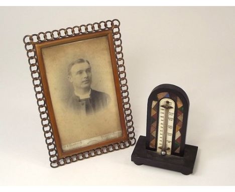 DEVON MARBLE ETC.
An inlaid Torquay marble thermometer, named to the ivorine plaque, height 14cm & a brass mounted photograph