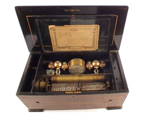 A large inlaid mahogany and walnut music box playing eight airs with six bells and seven hammer drum strikes (three missing c
