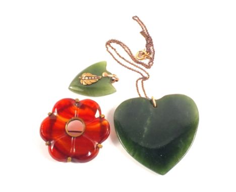 A large jade heart pendant, smaller jade pendant set with seed pearls plus one other brooch
