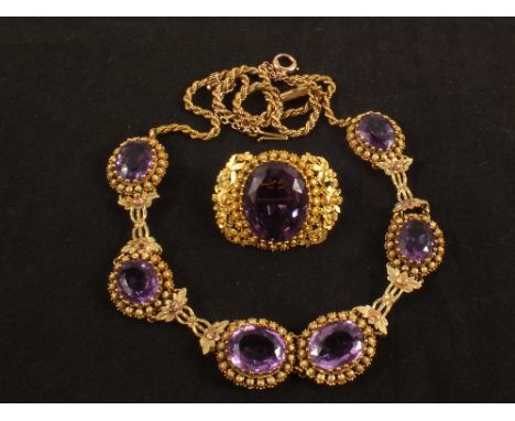 An unmounted yellow metal necklace made up of large amethyst stones mounted in ornate borders with later added gold chain, to