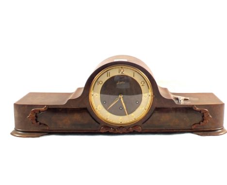 An oak cased striking mantel clock