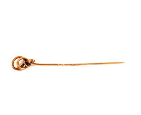 A gold stick pin in the form of a snake