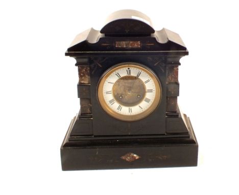 A black marble striking mantel clock