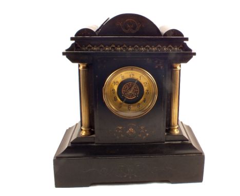 A black marble striking mantel clock