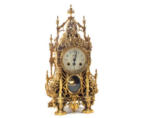 A gilt metal architectural mantel clock