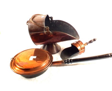 A 19th Century copper coal helmet, warming pan and scoop