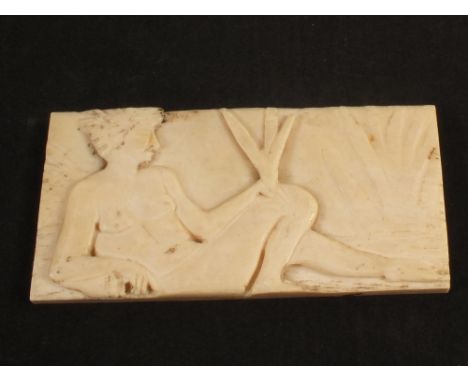 A vintage African ivory plaque of a reclining man, 2 1/2" x 5"