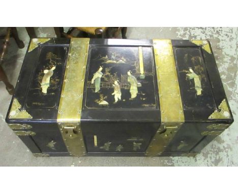 ORIENTAL TRUNK, circa 1940, ebonised and brass bound decorated in relief with figures and hinged top with camphor lined inter