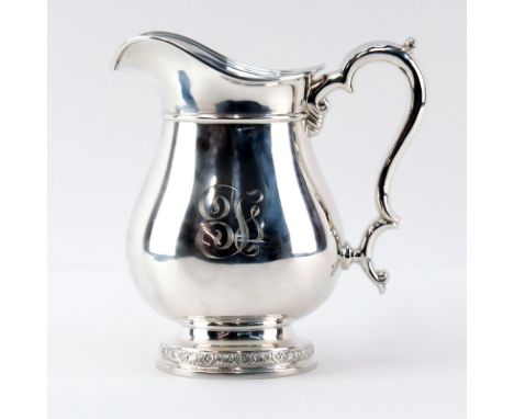 International Sterling Silver Pitcher. Signed. Monogrammed, shallow dings. Measures 9" H and weighs approx. 22.85 troy ounces