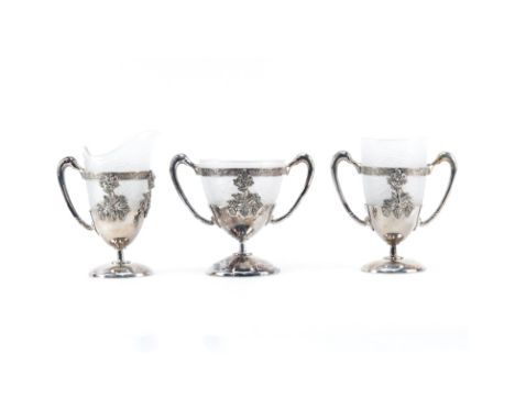 Three Pieces Aurora Silver Plate and Glass Table Top Items. Includes 2 handled cups and a pitcher. Signed. Small flake on the