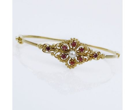 Vintage 14 Karat Yellow Gold Hinged Bangle Bracelet with Round Cut Rubies and White Pearls. Unsigned. Good vintage condition.