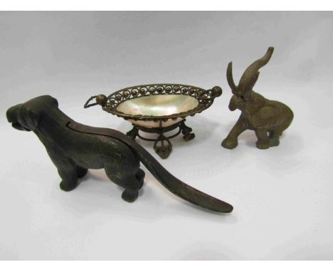 A bronzed pewter elephant figure, cast iron dog nut cracker and a pearlescent shell bowl (3)