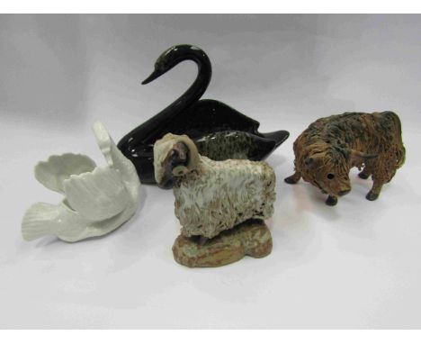 A pottery ram and bull and two ceramic swan figures   