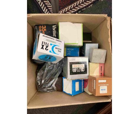 A box containing a collection of lenses and accessories including Schneider enlarger lens and converters