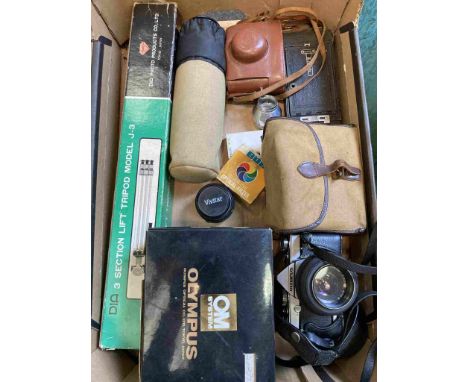 A box of mixed cameras including Olympus OM-1, Kodak folding camera and tripod etc