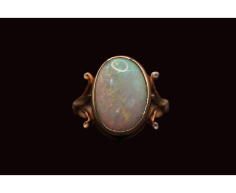 Ladies 9ct Gold Oval Opal ring, set with Opal measuring 16mm x 11mm within rub over setting and fleur-de-lys shoulders. Size 