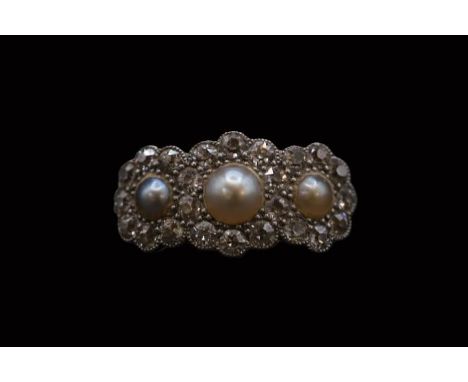 Edwardian 18ct Gold Pearl and Diamond set ring, Set with 3 half Cut pearls surrounded by Facetted Diamonds within rub over se