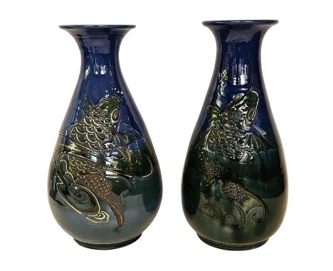 C. H. Brannam pottery matched pair of baluster vases, c.1902, each incised and relief decorated in coloured slips Stylised Ca