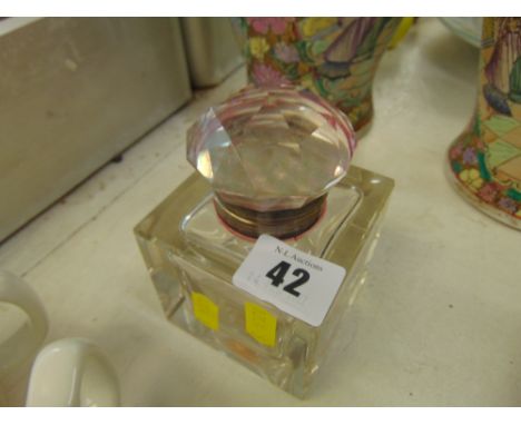 A heavy glass inkwell