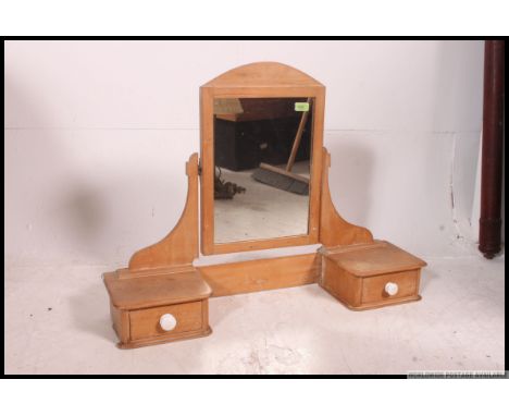 A Victorian pine swivel dressing table swing mirror flanked by twin trinket drawers. measures: 66 x 88 x 23 cm.