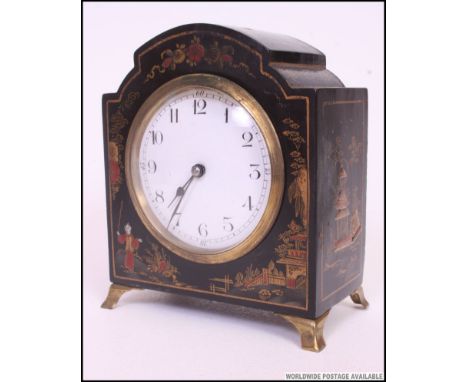 A 1930's Japanese chinoserie decorated mantel clock. French brass movement with enamel face. All raised on gilt claw feet.
