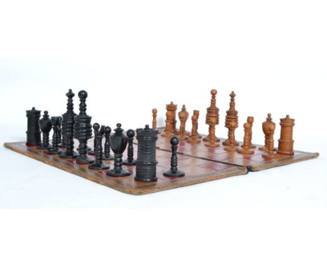A finely carved 20th century boxwood  and ebony chess set in the manner of William Lund with leather embossed board ( complet