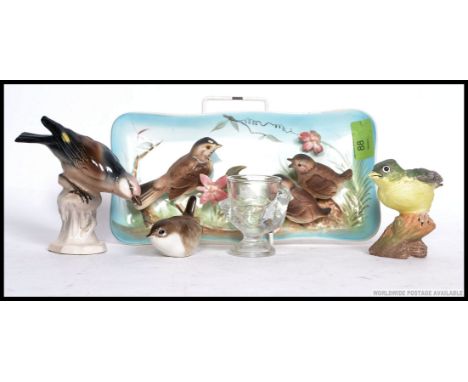 An unusual ceramic wall plaque cast in relief with British birds. Stamped to the verso Rubian? Together with other bird figur