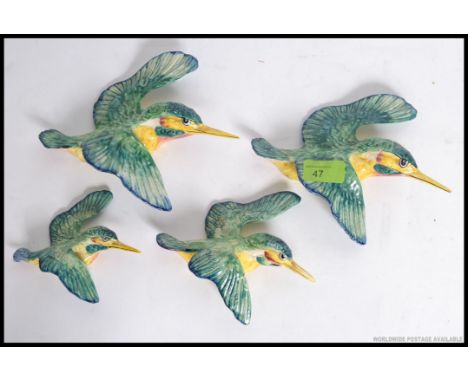 A set of 4 Beswick ceramic Kingfisher wall mounted polychrome figurines. Stamped to verso.  20cm long