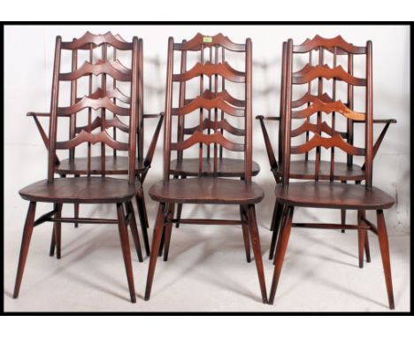 A set of six mid century Ercol elm bar back and spindle dining chairs in the Gothic style, consisting of two carvers and four