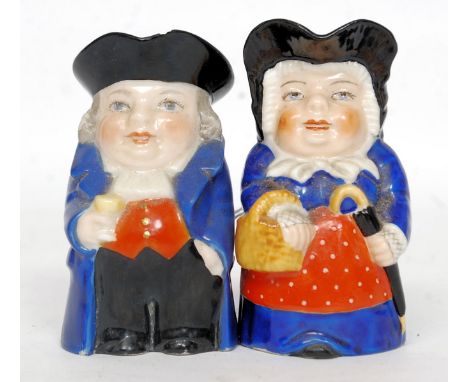 A pair of Royal Worcester male and female miniature toby jugs, he holding a church warden pipe and a mug, she with an umbrell