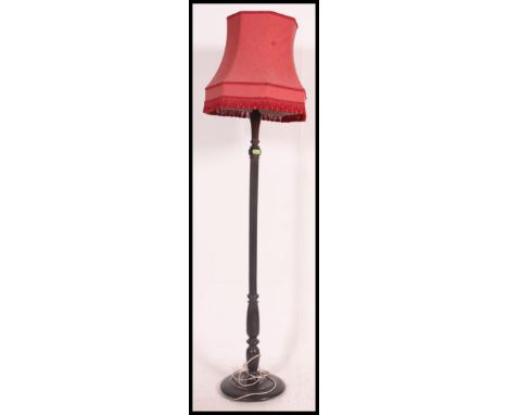 A mid century mahogany standard lamp complete with shade having terraced base with turned stem. H188 x  Shade width 60cm 