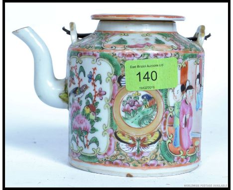 A 19th century Chinese / Cantonese famille rose teapot. The panels with family scenes having wire handle with ceramic top. H1