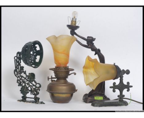 A collection of vintage wall lights and table lamps to include a deco style lamp, oil lamp and wall sconces