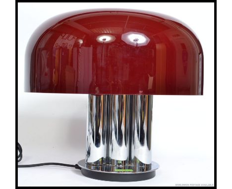 A stylish retro 1960's / 1970's chrome table lamp, having a three sectional chrome base bellow a bulbous deep red plastic sha