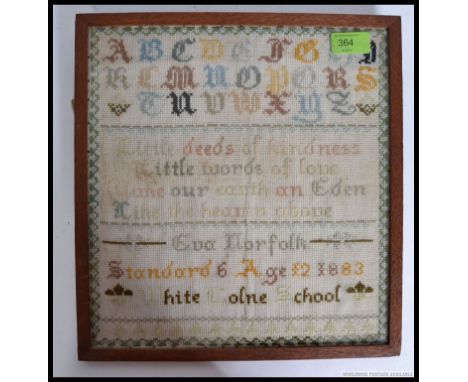 An Essex Victorian tapestry needlepoint sampler by Eva Norfolk Aged 12 1883 at White Colne School. H31 x W29cm 