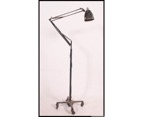 A large Herbert Terry anglepoise Industrial floor standing anglepoise lamp set over quadruped castor base. Pendant shade with