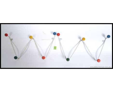 A pair of retro 1950's atomic / sputnik style wall mounted coat racks with colourful finial ends