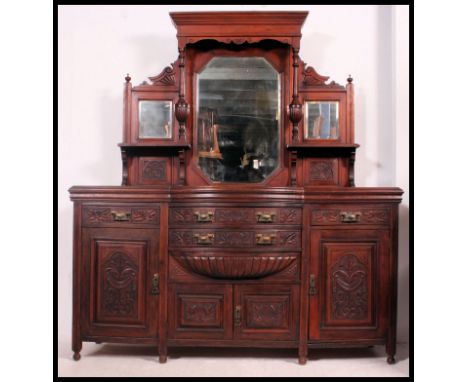 A Victorian mahogany bow front mirror back sideboard. The base with a series of cupboards and drawers having brass handles. A