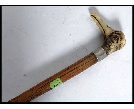 An amusing gentlemans walking cane / stick having a horn  handle in the form of a Cormorant, inset glass eyes, white metal co