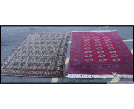 Two floor rugs of Middle Eastern design the first having a Kashon Super label applied, both being of geometric design. Measur