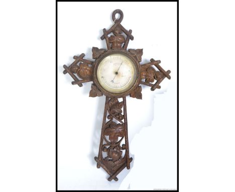 A good sized 19th century Victorian carved oak wall barometer set on carved crucifix - cross with the silvered marked for ' J
