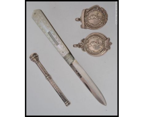 A silver hallmarked penknife with mother of pearl handle together with a silver propelling pencil, silver toothpick and 2 sil