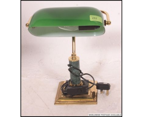 A contemporary vintage style green glass bankers lamp, on a brass metal base. 