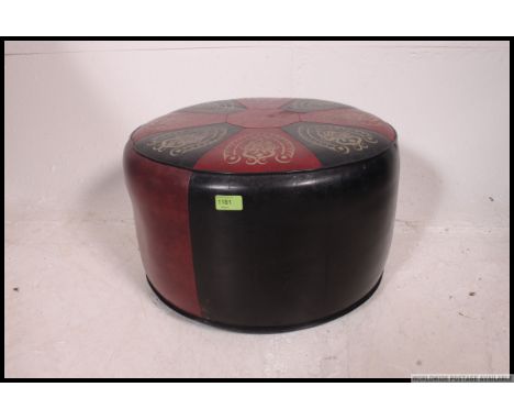 A retro mid century two tone vinyl panel stitched pouffe, having a geometric design to the top
